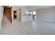 Bright living room with neutral walls, tile flooring, and an opening looking into the kitchen and stairs at 125 Sam Jonas Dr, Las Vegas, NV 89145