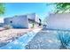 Exterior condo view features a stucco facade, concrete pathway, and desert landscaping at 1326 N Jones Blvd, Las Vegas, NV 89108