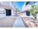 Condo exterior featuring stucco facade, concrete pathway, minimal desert landscaping, and secure doors at 1326 N Jones Blvd, Las Vegas, NV 89108
