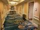 Elegant hallway featuring a unique patterned carpet, modern lighting, and access to elevators at 135 E Harmon Ave # 3217, Las Vegas, NV 89109