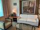 Well-lit living room with comfortable seating, including a sofa and armchair, and a glass table for added convenience at 135 E Harmon Ave # 3217, Las Vegas, NV 89109