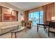Comfortable living room with a sofa, armchair, a glass table and balcony overlooking the city at 135 E Harmon Ave # 3217, Las Vegas, NV 89109