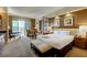 Well-lit main bedroom featuring a king-sized bed, sitting area, and a beautiful city view from the balcony at 135 E Harmon Ave # 3217, Las Vegas, NV 89109