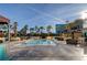 Image shows an outdoor pool surrounded by palm trees, lounge chairs, and cabanas on a sunny day at 135 E Harmon Ave # 3217, Las Vegas, NV 89109