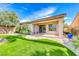 Landscaped backyard showcasing an artificial grass area, patio, and desert-friendly plants at 14 Hunt Valley Trl, Henderson, NV 89052