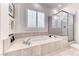Spa-like bathroom features a soaking tub, walk-in shower, and bright natural light at 14 Hunt Valley Trl, Henderson, NV 89052