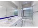 A clean bathroom featuring a shower-tub combo, white tiles, and a modern sink at 14 Hunt Valley Trl, Henderson, NV 89052