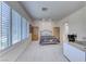 Bright bedroom has shuttered windows, neutral carpet, and plenty of natural light at 14 Hunt Valley Trl, Henderson, NV 89052