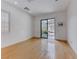 Bright bonus room with wooden floors and sliding glass doors to the backyard patio at 14 Hunt Valley Trl, Henderson, NV 89052