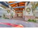 Beautiful building entrance with stone accents, wood beams and wreaths for a touch of seasonal decor at 14 Hunt Valley Trl, Henderson, NV 89052