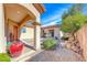Charming courtyard with decorative pots, rock features, and lush landscaping, perfect for relaxation and entertaining at 14 Hunt Valley Trl, Henderson, NV 89052