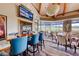 Elegant dining room boasts a view of the golf course and a wall-mounted television for enjoyment at 14 Hunt Valley Trl, Henderson, NV 89052