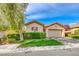 Charming single-story home featuring a well-maintained lawn, mature tree, and an attached two-car garage at 14 Hunt Valley Trl, Henderson, NV 89052