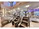 Fully-equipped fitness center with state-of-the-art treadmills and stair climbers facing mounted televisions at 14 Hunt Valley Trl, Henderson, NV 89052