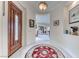 A pristine foyer featuring a decorative front door, an elegant rug, tile flooring, and views into the living area at 14 Hunt Valley Trl, Henderson, NV 89052