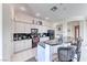 Stylish kitchen includes stainless appliances, white cabinetry, and a breakfast bar for seating at 14 Hunt Valley Trl, Henderson, NV 89052