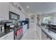 Bright kitchen features sleek black appliances, granite counters, and a window with natural light at 14 Hunt Valley Trl, Henderson, NV 89052