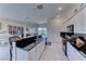 Open-concept kitchen features a large island with bar seating, granite countertops, and modern appliances at 14 Hunt Valley Trl, Henderson, NV 89052