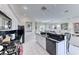 Open concept kitchen with modern appliances, granite counters, and seamless flow to the dining area at 14 Hunt Valley Trl, Henderson, NV 89052