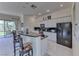 Well-lit kitchen boasts modern appliances, granite countertops, and a breakfast bar for casual dining at 14 Hunt Valley Trl, Henderson, NV 89052