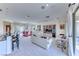 An open concept living room and dining area with ample natural light and plush seating, adjacent to the kitchen at 14 Hunt Valley Trl, Henderson, NV 89052