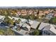 Bird's-eye view of homes with well-kept lawns, palm trees, and mountain views showcasing a Gathering-friendly neighborhood at 1508 Sun Copper Dr, Las Vegas, NV 89117