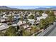 An aerial view displays a community with homes featuring pristine roofs, manicured lawns, and mature palm trees at 1508 Sun Copper Dr, Las Vegas, NV 89117