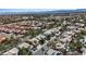 Expansive aerial view of a neighborhood with well-maintained homes, palm trees, and a mountain backdrop on a sunny day at 1508 Sun Copper Dr, Las Vegas, NV 89117