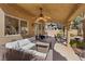 Spacious covered patio features comfortable seating, ceiling fans, and lighting creating a relaxing outdoor living area at 1508 Sun Copper Dr, Las Vegas, NV 89117