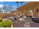 Large backyard features a covered patio, gravel landscaping, and ample space for outdoor activities at 1508 Sun Copper Dr, Las Vegas, NV 89117