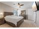 Bedroom featuring a king bed, ceiling fan, nightstand, dresser, wall mirror, and mounted television at 1508 Sun Copper Dr, Las Vegas, NV 89117
