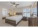 Bedroom featuring a king bed, ceiling fan, nightstand, dresser, wall mirror, and closet with mirrored doors at 1508 Sun Copper Dr, Las Vegas, NV 89117