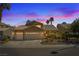 Dusk view of a home with a three-car garage and desert landscaping at 1508 Sun Copper Dr, Las Vegas, NV 89117