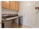 Laundry room with modern washer and dryer units, storage cabinets, and a convenient layout at 1508 Sun Copper Dr, Las Vegas, NV 89117
