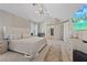 Bright main bedroom with a ceiling fan, neutral tones, and access to the ensuite bathroom at 1508 Sun Copper Dr, Las Vegas, NV 89117