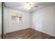 This cozy bedroom features wood floors, a window, ceiling fan, and neutral paint throughout at 1837 Alicant Way, Henderson, NV 89014