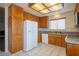 Traditional kitchen with white appliances, tile countertops and backsplash, and paneled wood cabinets at 1837 Alicant Way, Henderson, NV 89014