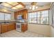 Bright kitchen with white appliances, wood cabinets, and a large window at 1837 Alicant Way, Henderson, NV 89014