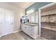 Bathroom featuring a double sink vanity with granite countertops and a walk-in closet at 1921 Lewis Bay Ave # Lot 21, North Las Vegas, NV 89084