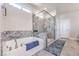 Contemporary bathroom with a soaking tub and glass-enclosed shower, plus neutral color palette at 1921 Lewis Bay Ave # Lot 21, North Las Vegas, NV 89084