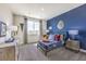 This bedroom features a cool blue accent wall, plush textures and lots of light at 1921 Lewis Bay Ave # Lot 21, North Las Vegas, NV 89084