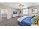 Well-lit bedroom with a large window, ceiling fan, and modern decor at 1921 Lewis Bay Ave # Lot 21, North Las Vegas, NV 89084