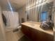 Well-lit bathroom features a vanity, shower, and soaking tub, providing a relaxing space at 200 W Sahara Ave # 2211, Las Vegas, NV 89102