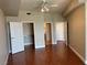 Bright bedroom features hardwood floors, a ceiling fan, and an open closet for easy organization at 200 W Sahara Ave # 2211, Las Vegas, NV 89102