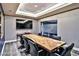 Modern conference room featuring large screen TV, natural wood table, and comfortable chairs at 200 W Sahara Ave # 2211, Las Vegas, NV 89102