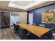 Contemporary conference room with a long wooden table and unique water feature, ideal for meetings at 200 W Sahara Ave # 2211, Las Vegas, NV 89102