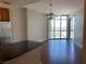 Living area with hardwood floors and a view of the city from floor-to-ceiling windows and access to a balcony at 200 W Sahara Ave # 2211, Las Vegas, NV 89102