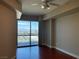 Bright main bedroom with floor-to-ceiling windows offering panoramic city views and hardwood floors at 200 W Sahara Ave # 2211, Las Vegas, NV 89102
