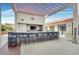 A shaded outdoor kitchen boasts a bar, TV, stainless steel appliances, and ample seating at 200 W Sahara Ave # 2211, Las Vegas, NV 89102
