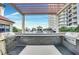 Stainless steel BBQ grills line this outdoor kitchen area with a pergola-covered dining space at 200 W Sahara Ave # 2211, Las Vegas, NV 89102